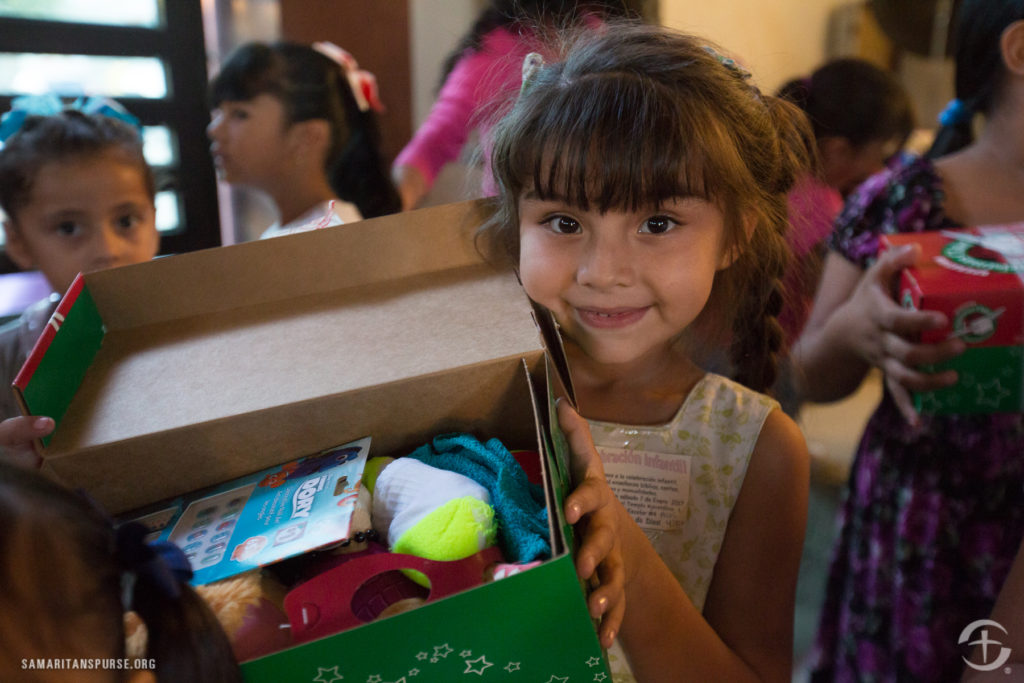 Child in Mexico holding their shoebox from Operation Christmas Child