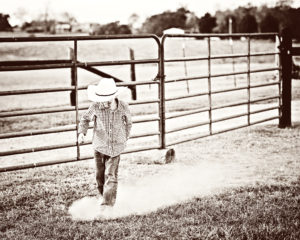 photo of my little cowboy kicking up dirt