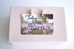 pink box with quote attached by clothespins