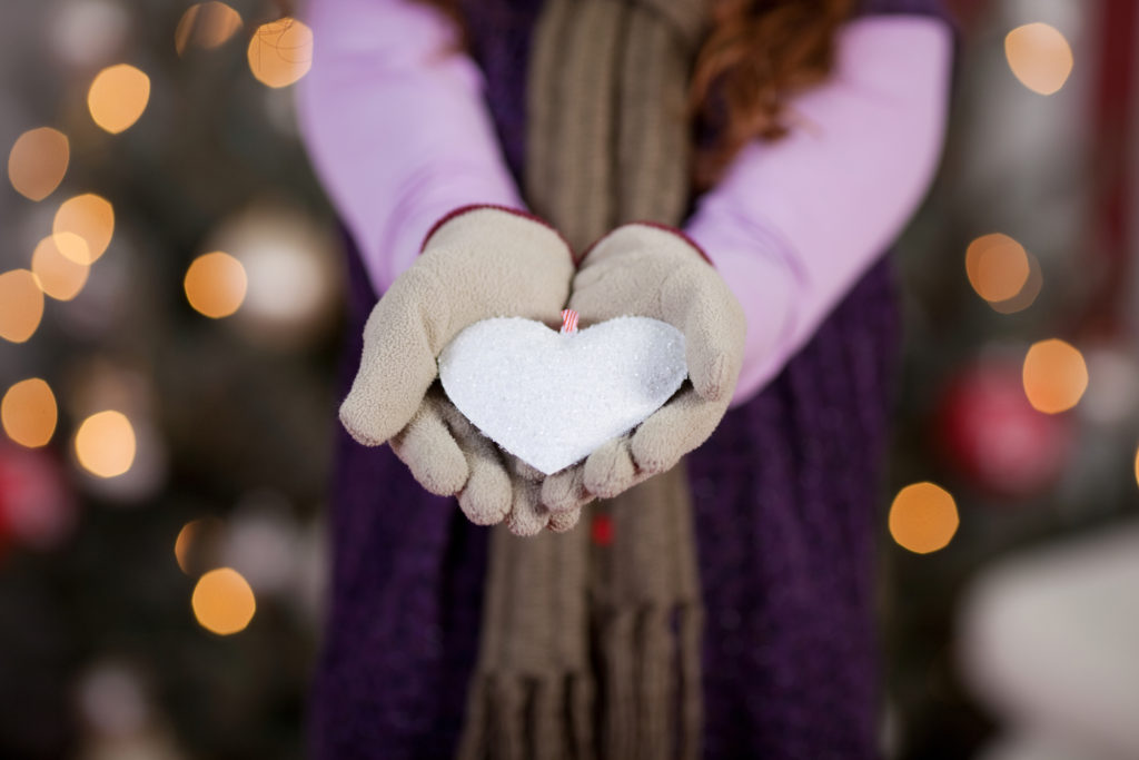 Child with white Christmas heart