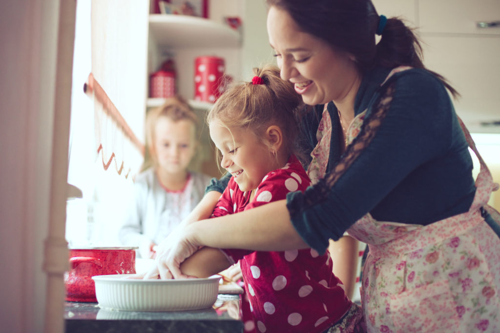 mother and children making memories baking together