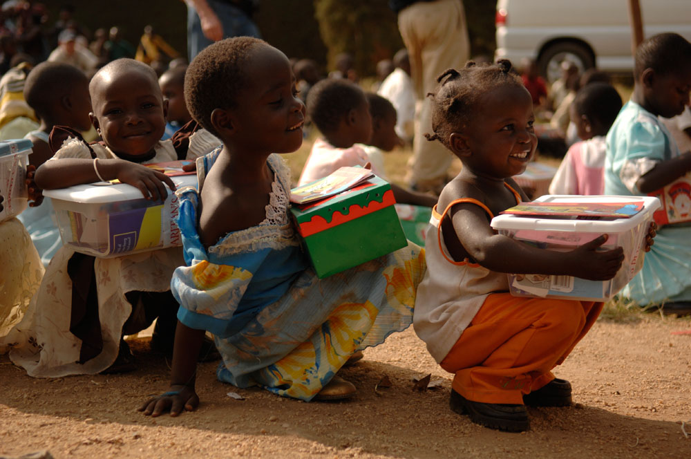 Children holding shoeboxed from Operation Christmas Child